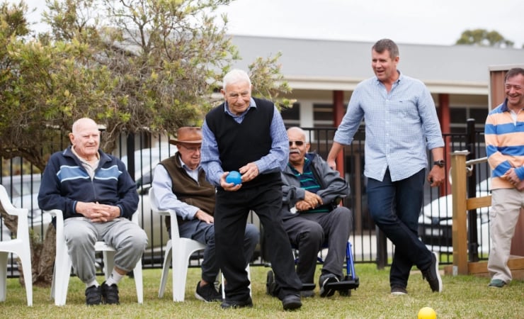 CEO Mike Baird plays bowls with a group of aged care residents