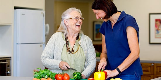 A woman and a carer prepare a meal at HammondCare Cardiff, an aged care home in Cardiff, NSW.
