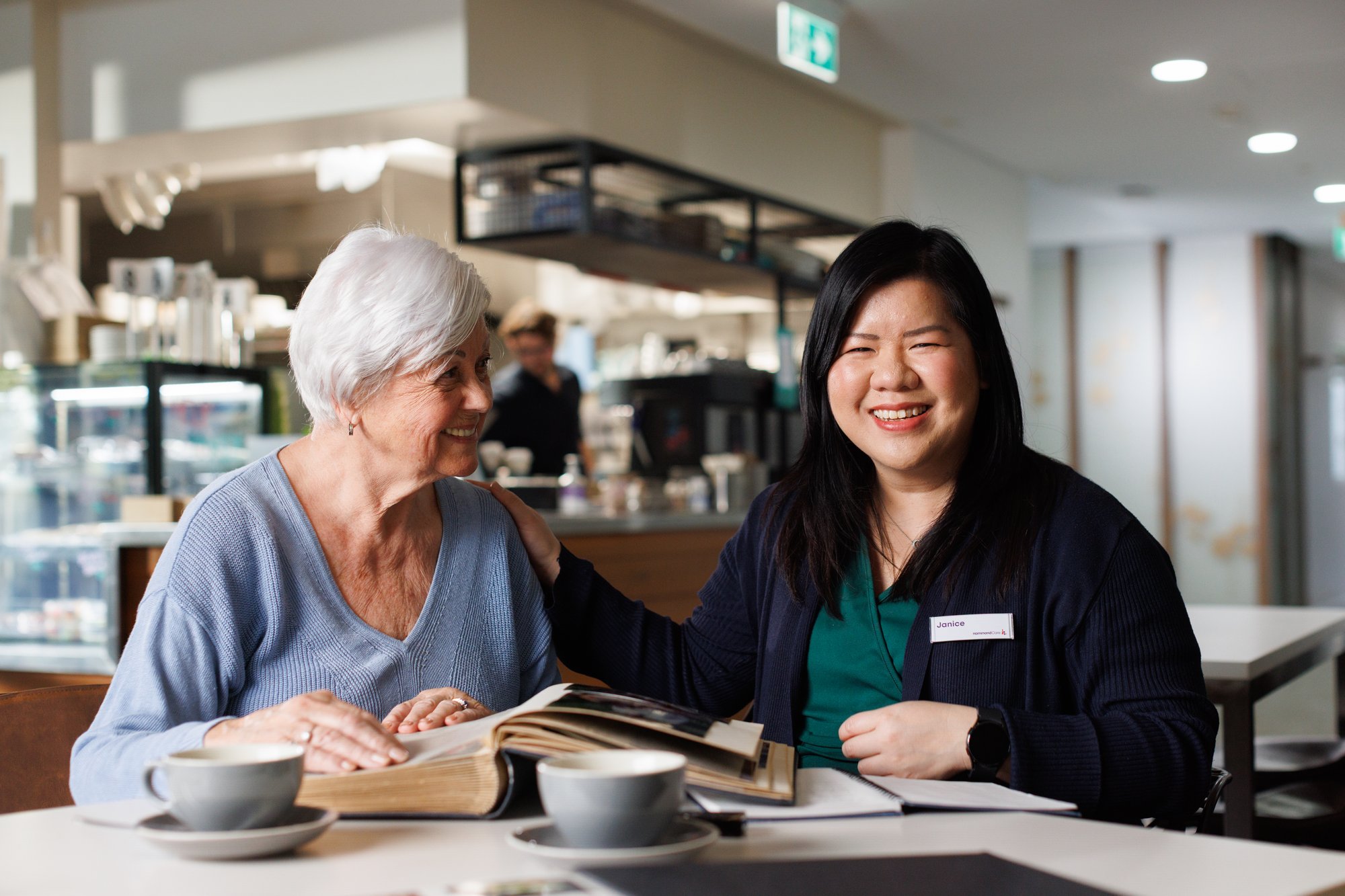 Resident sitting with carer doing HammondCare life stories program