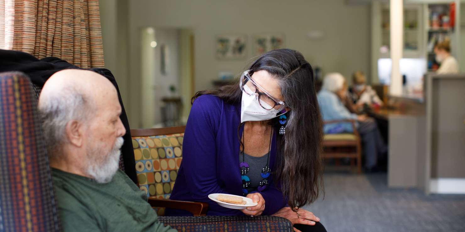 HammondCare worker sharing morning tea with a resident
