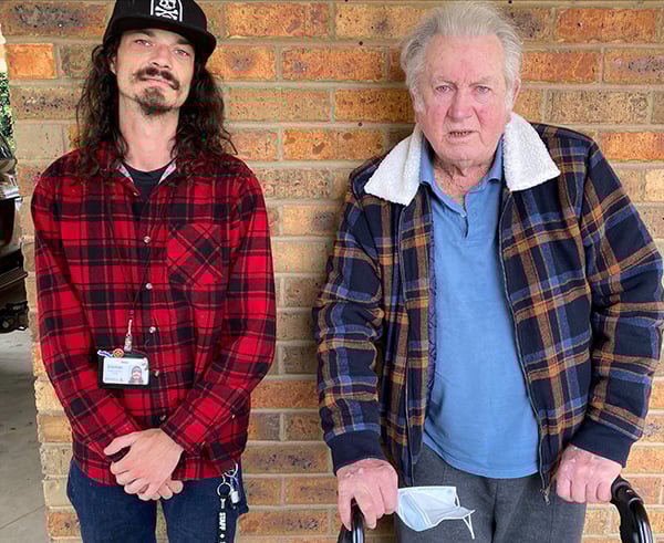 HCAH care worker Daniel Van Gelder stands with client Alex Perkins