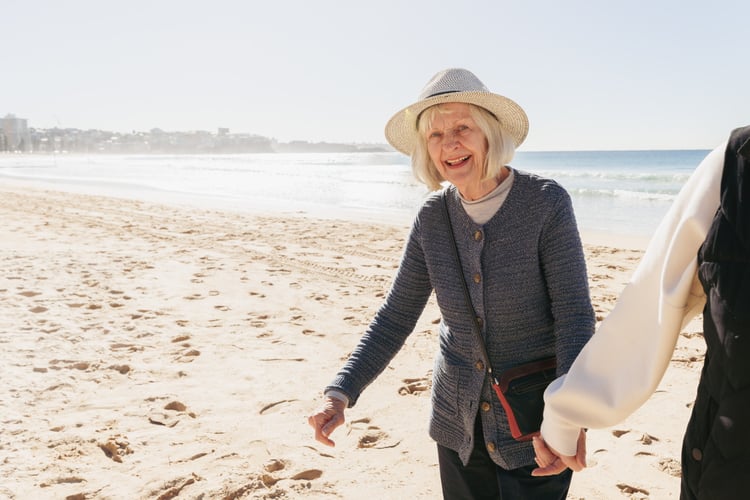 Woman walking on the beach with Social Club