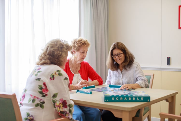 Women enjoying board games at HammondCare's Social Club