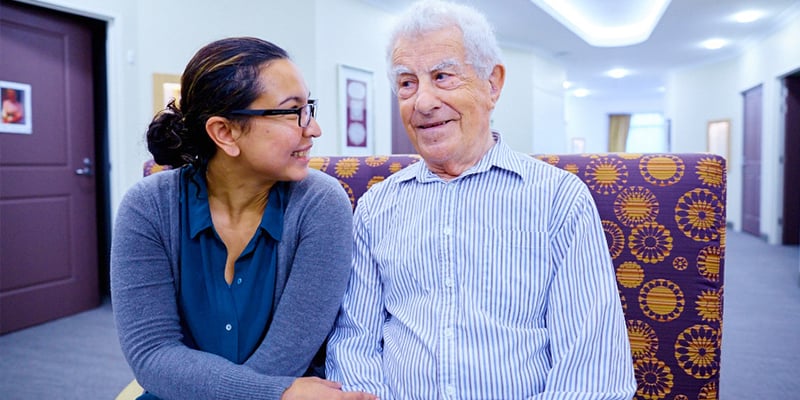 George sits in a care home with a carer