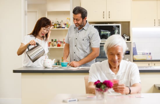 An older man and his family enjoy respite care at Jean Marion Cottage in Narara.