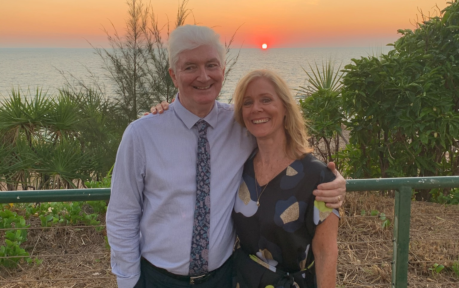 Sean and Jo Byrne standing in front of a sunset