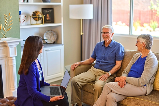 An older couple speak with a healthcare professional at HammondCare Miranda, an aged care home in Sydney's south.